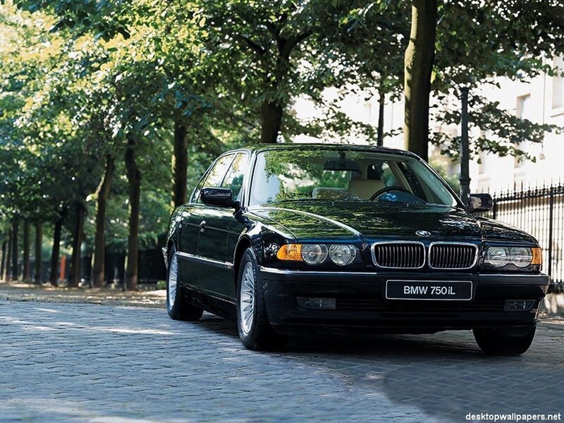 Black BMW 750iL on a tree-lined street