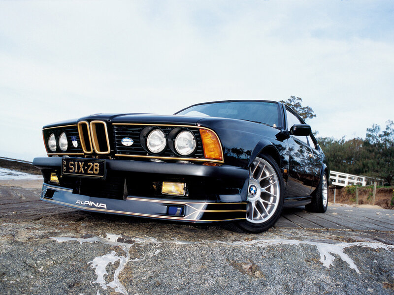 Black BMW Alpina on rocky shore