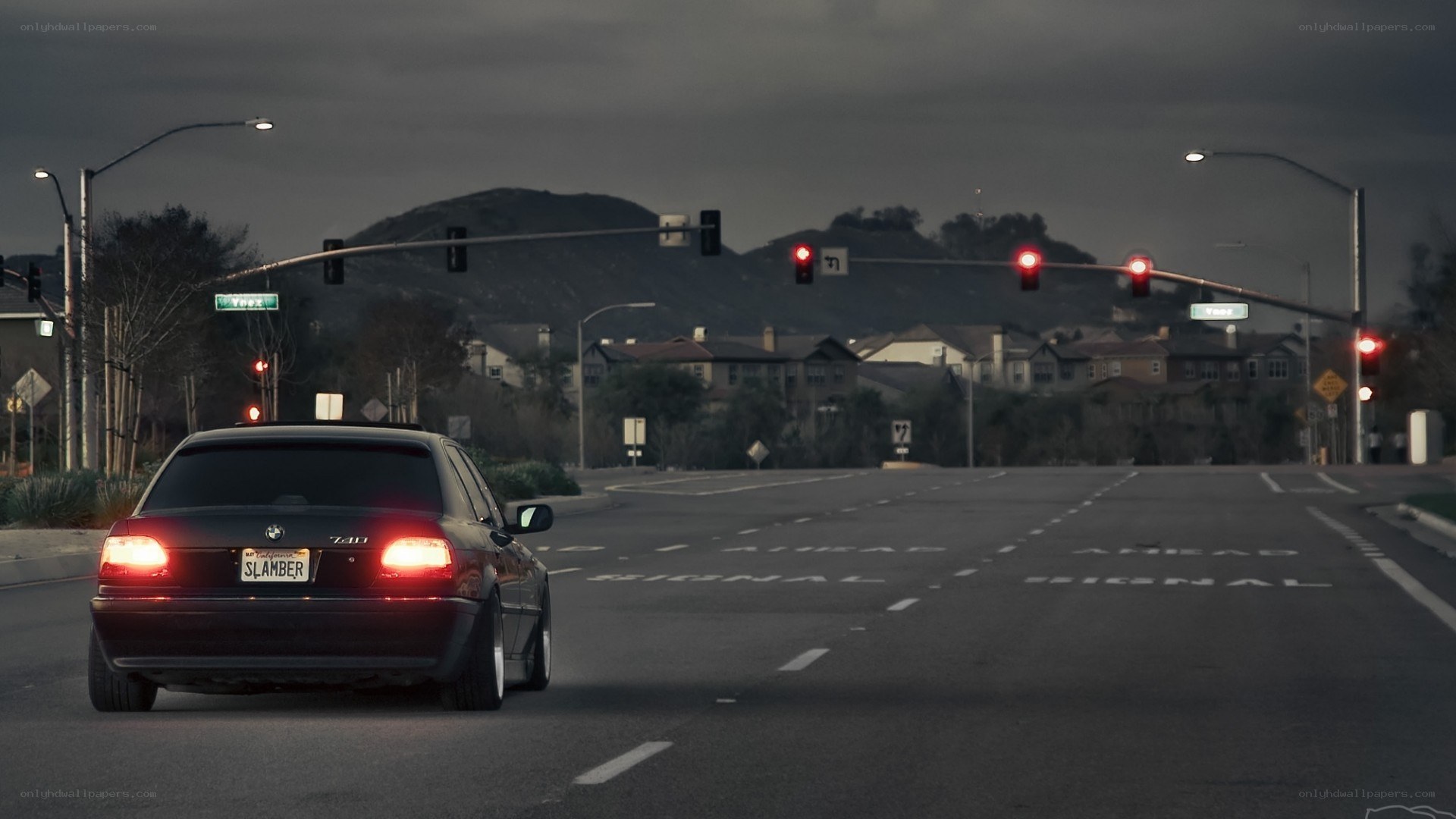 Black BMW at a red light
