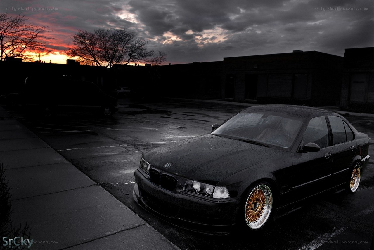 Black BMW at sunset