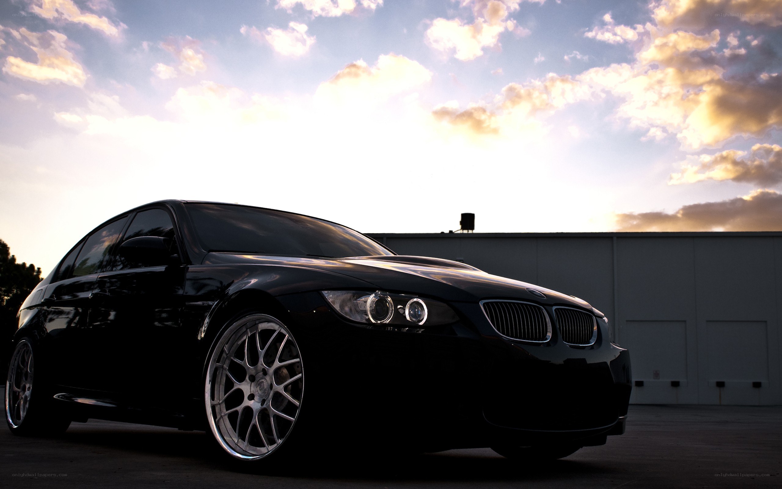 Black BMW at sunset