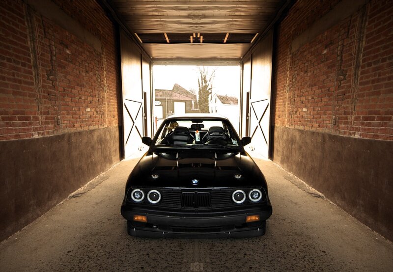 Black BMW Car — Dramatic, Afternoon, Photograph, Brick Walls