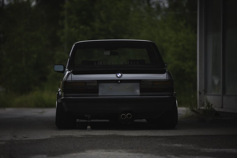 Black BMW Car — Dramatic, Photograph, Trees, Building