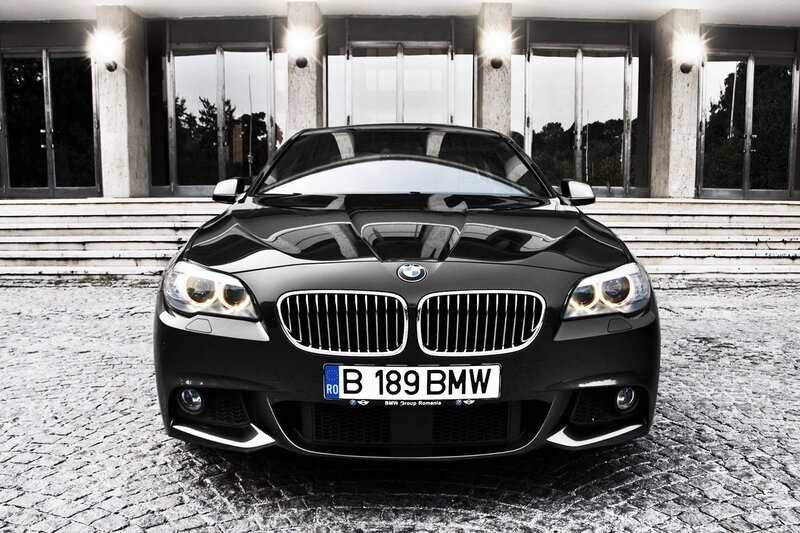 Black BMW car in front of building