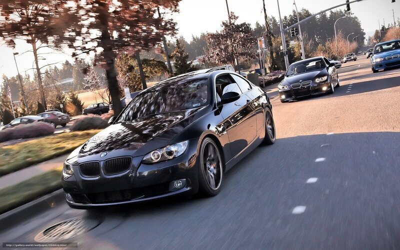 Black BMW cars on city street