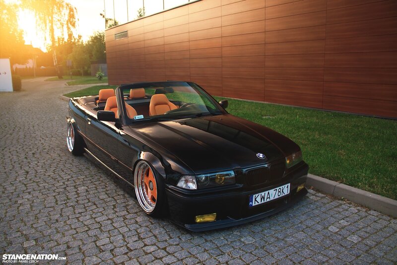 Black BMW convertible at sunset