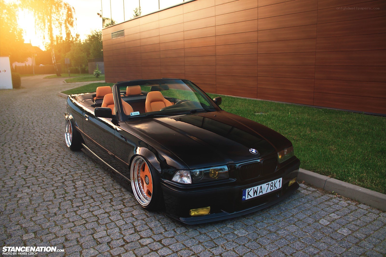 Black BMW convertible at sunset