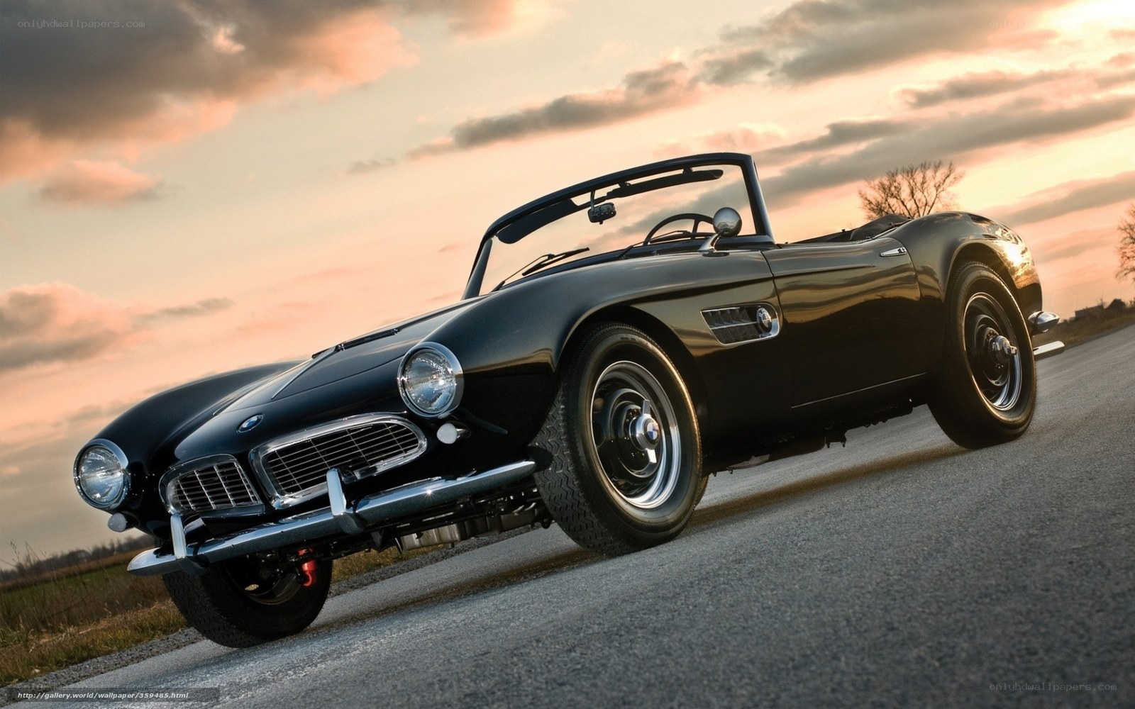 Black BMW convertible at sunset