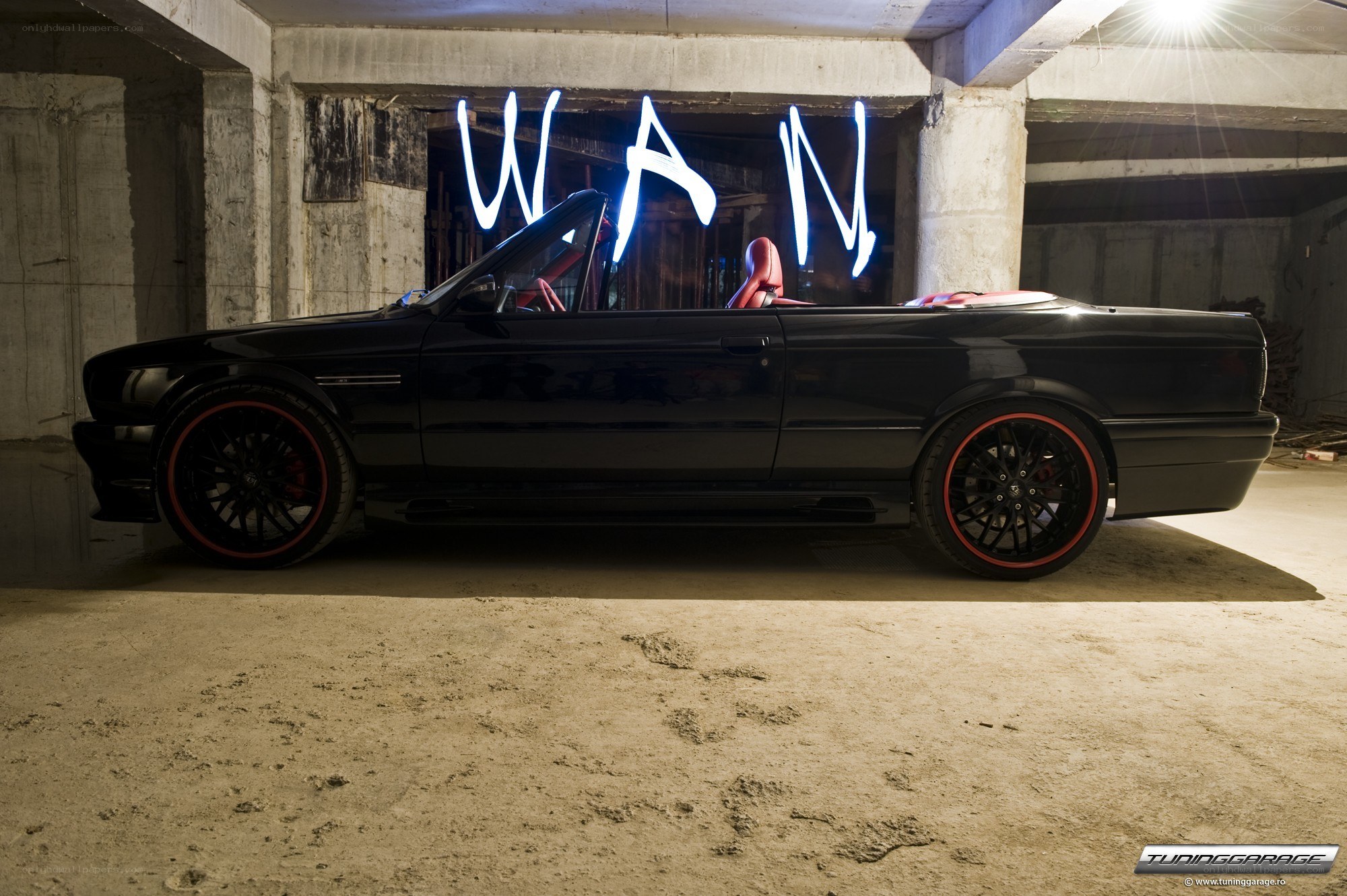 Black BMW convertible in garage