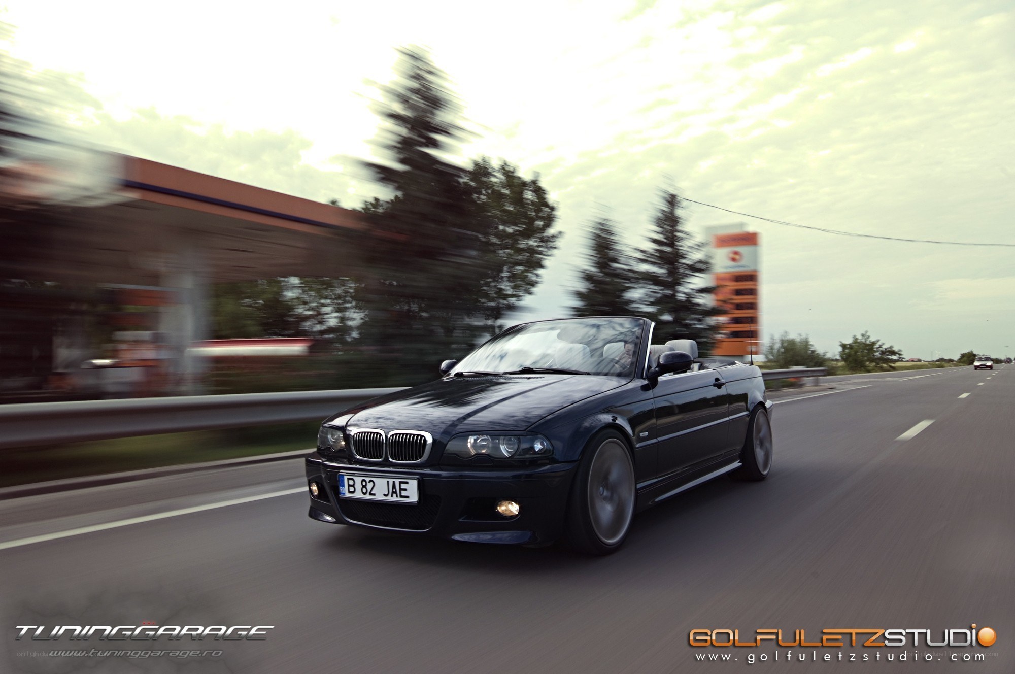 black bmw convertible in motion