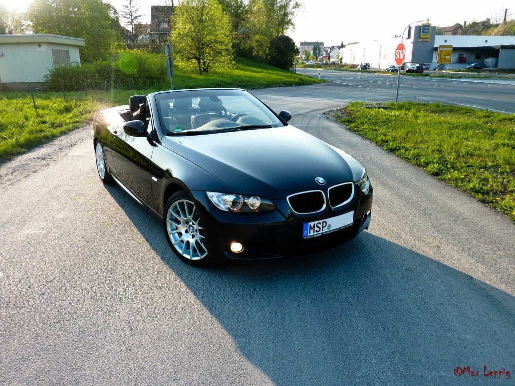 Black BMW convertible on a road