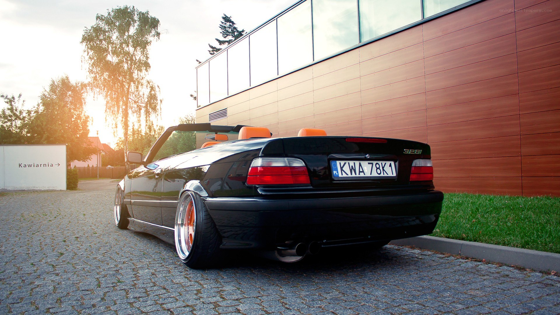 Black BMW convertible on cobblestones