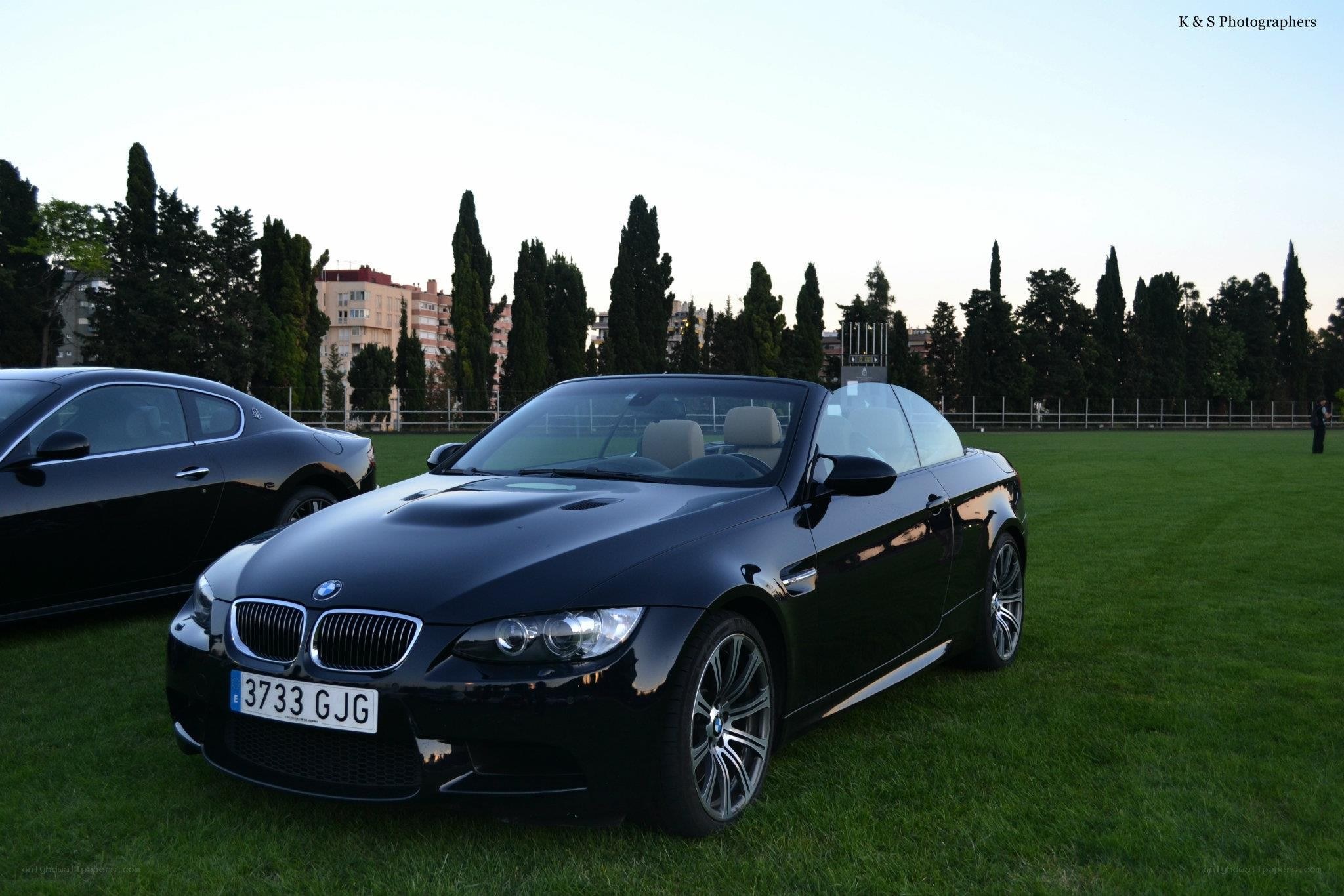 Black BMW convertible on grass
