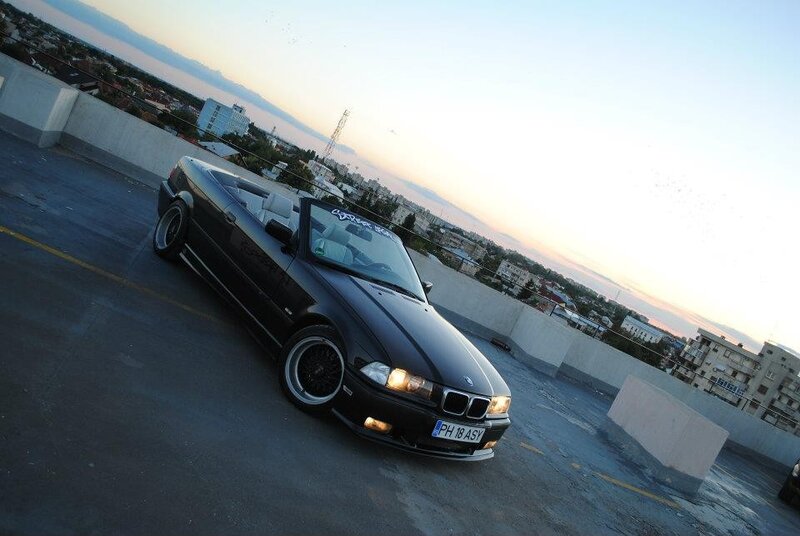 Black BMW convertible on rooftop