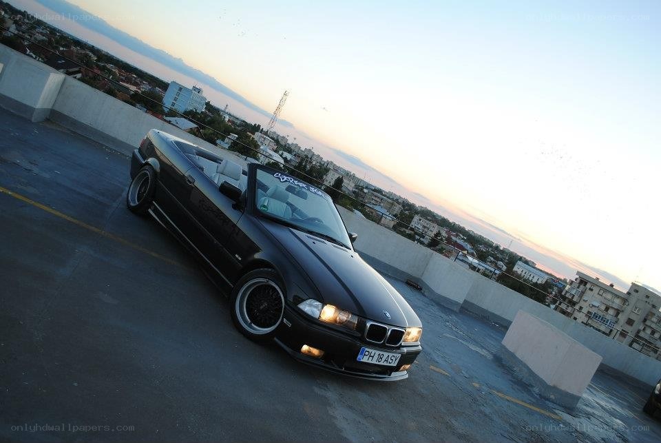 Black BMW convertible on rooftop