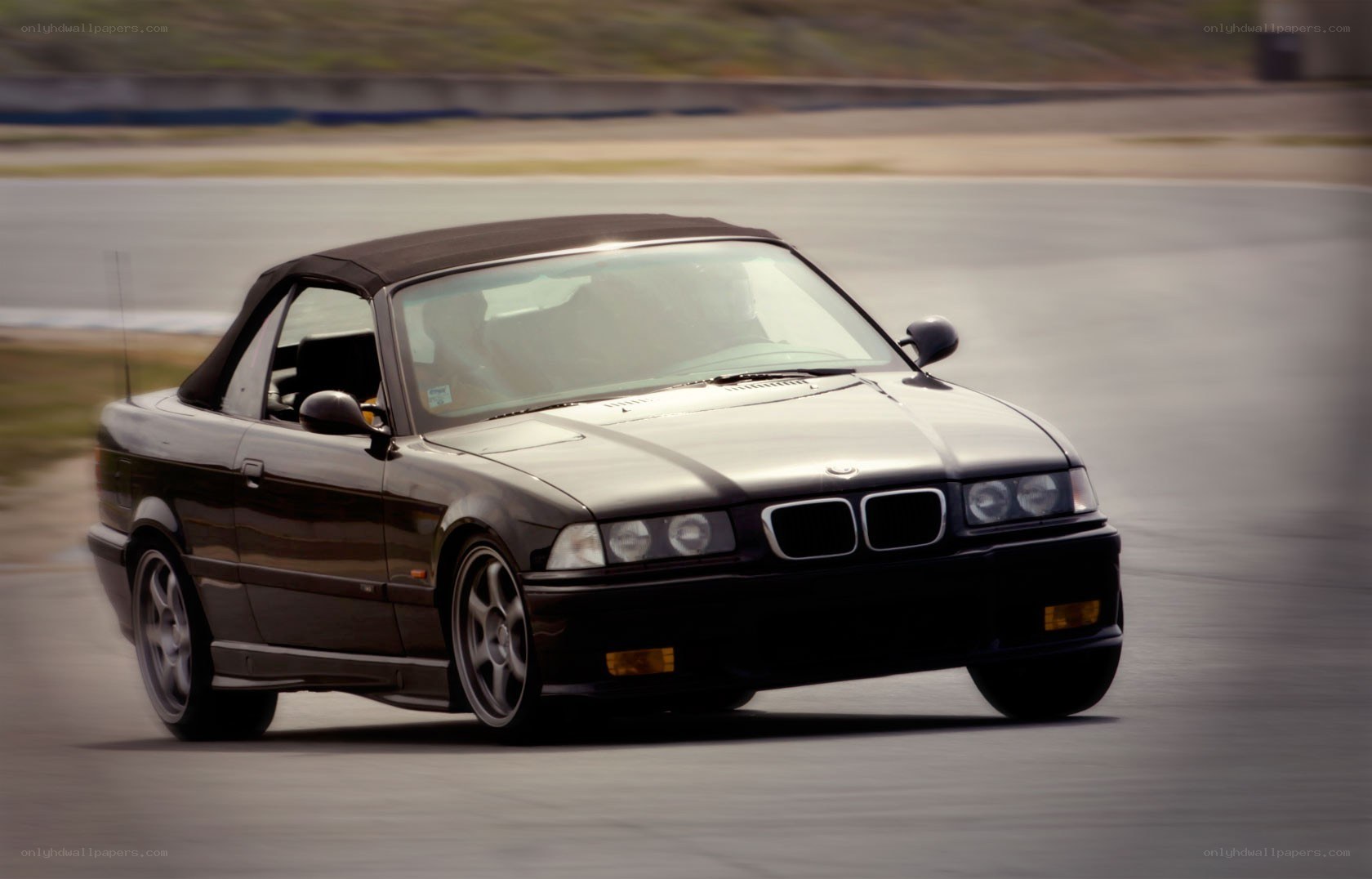 black bmw convertible on track
