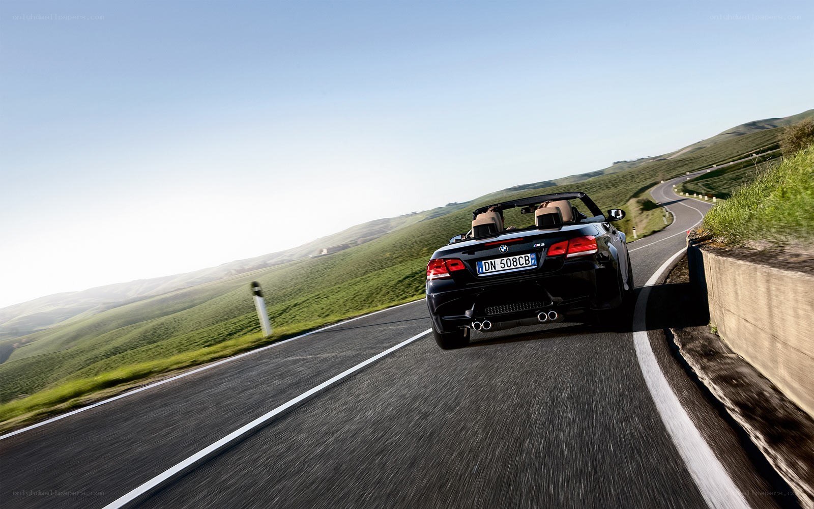 Black BMW convertible on winding road
