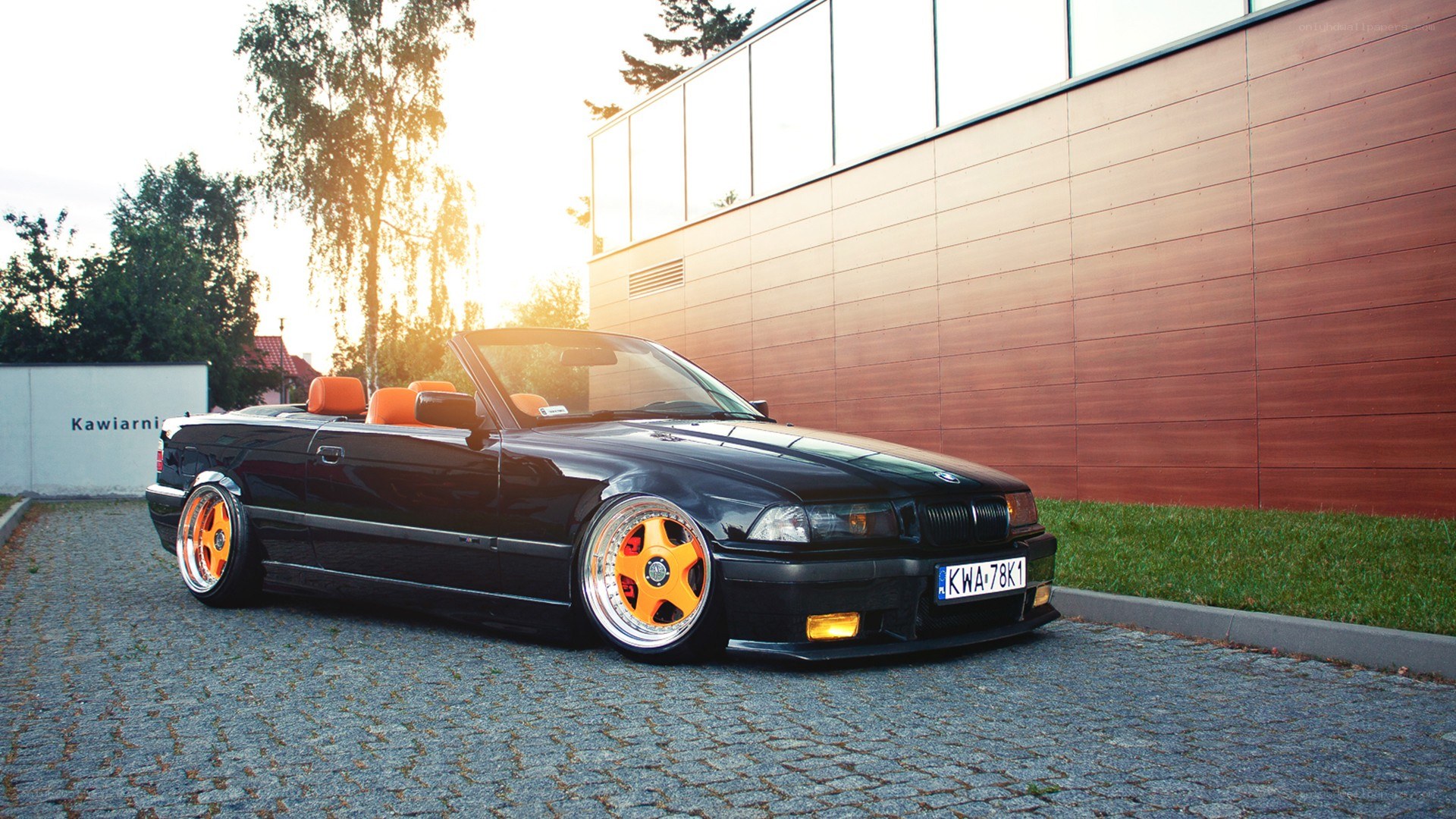 black bmw convertible with orange wheels