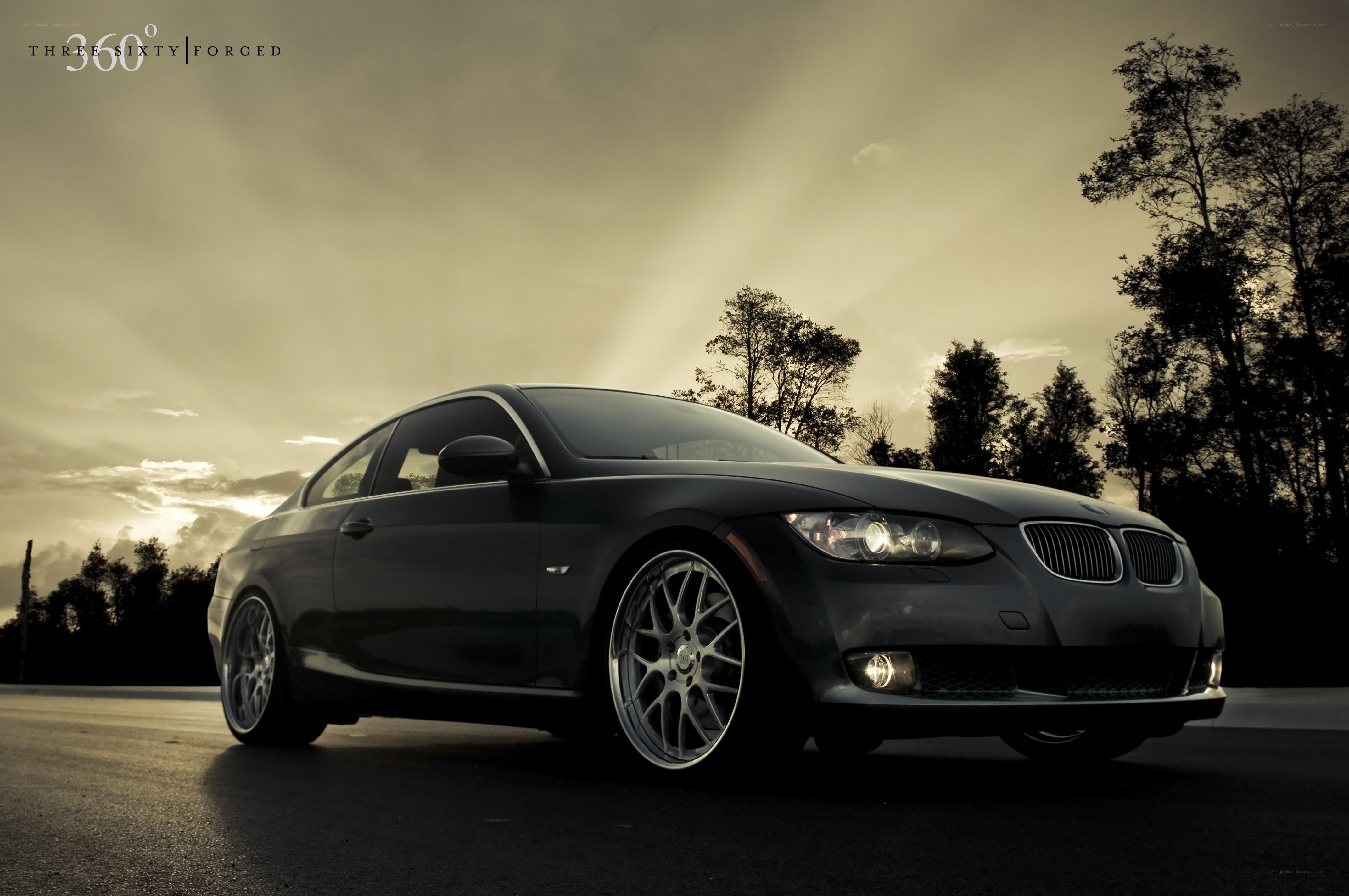 Black BMW coupe at sunset