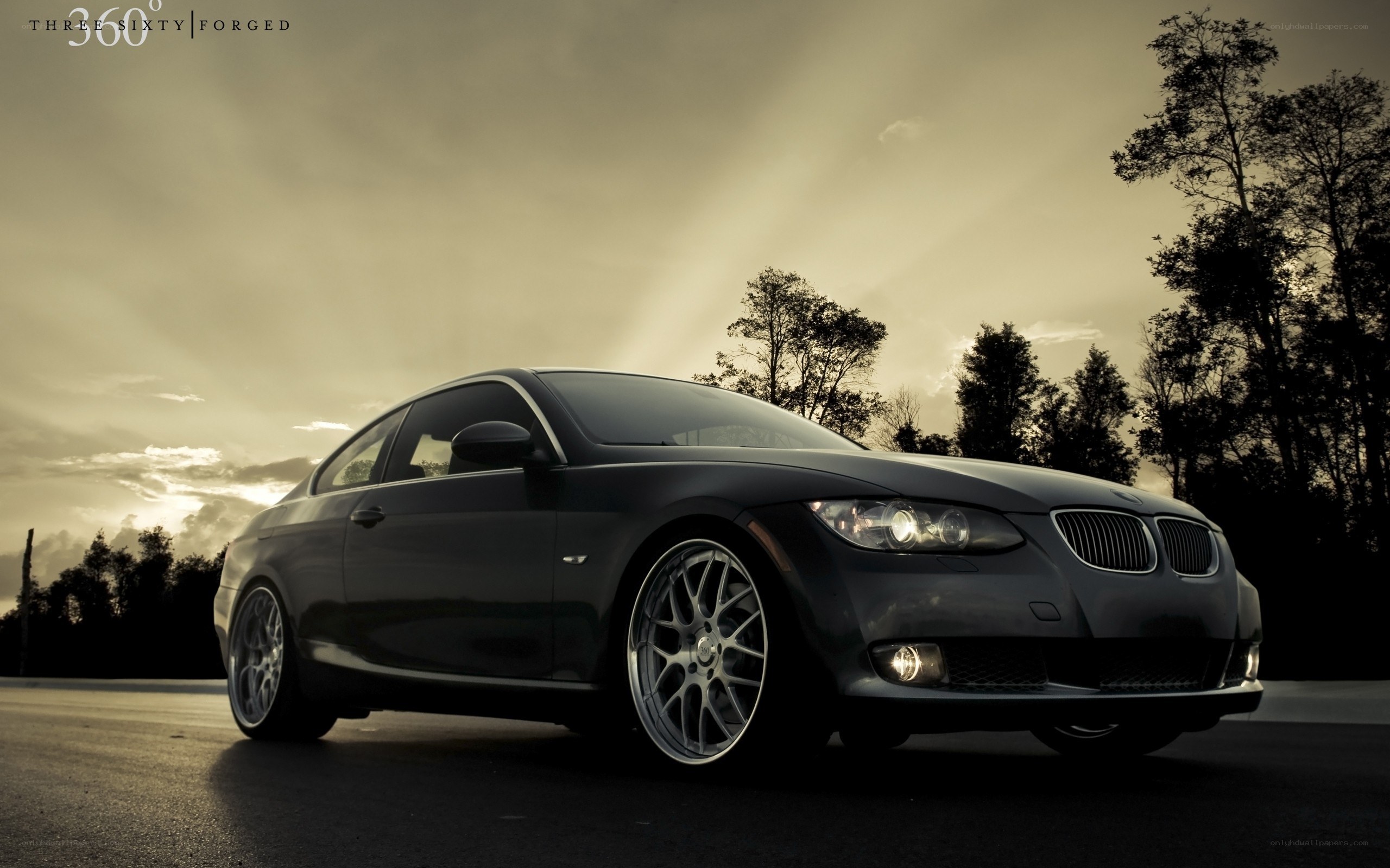 Black BMW coupe at sunset