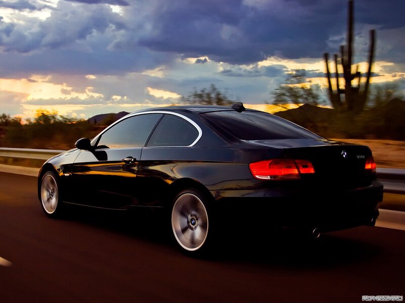black bmw coupe at sunset