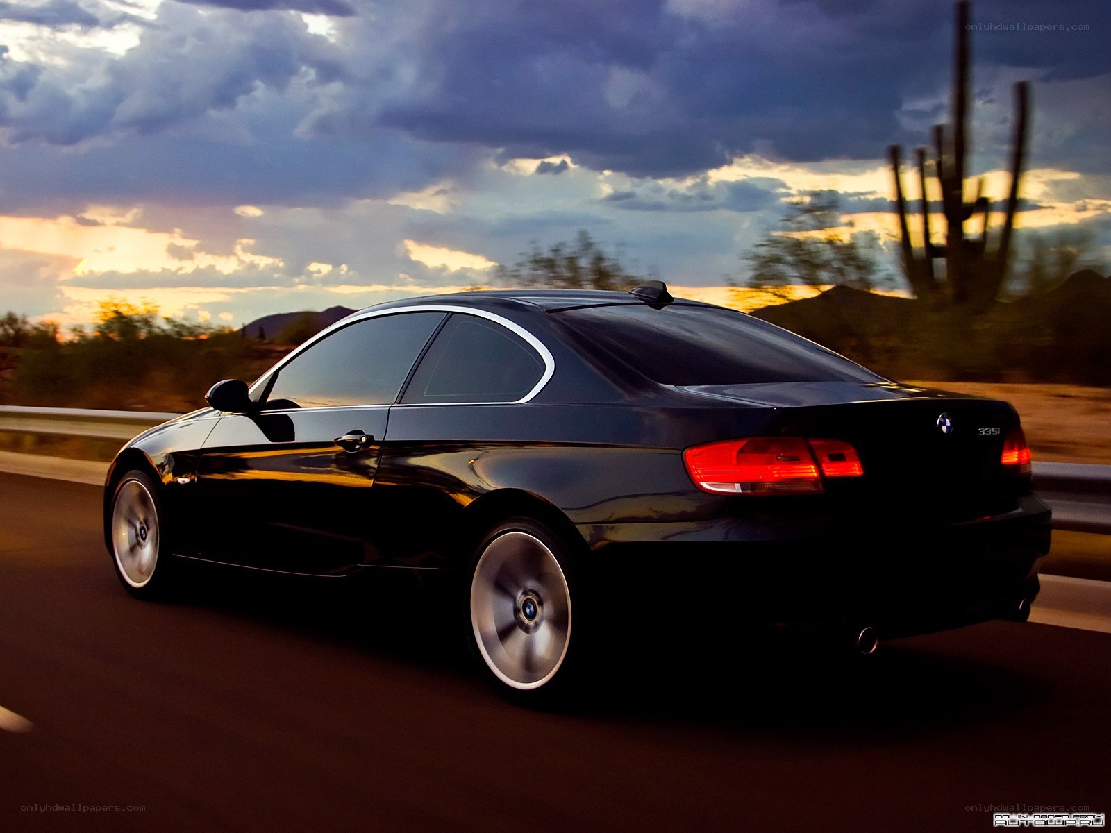 black bmw coupe at sunset