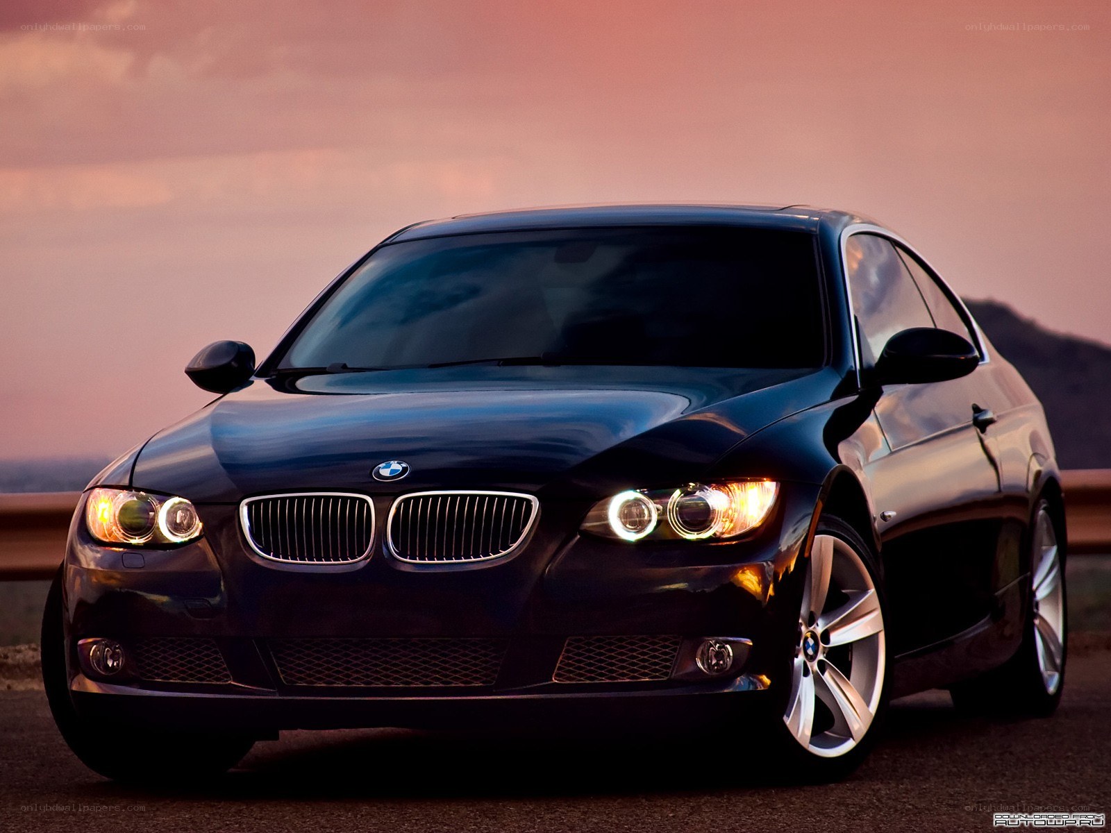 Black BMW coupe at sunset