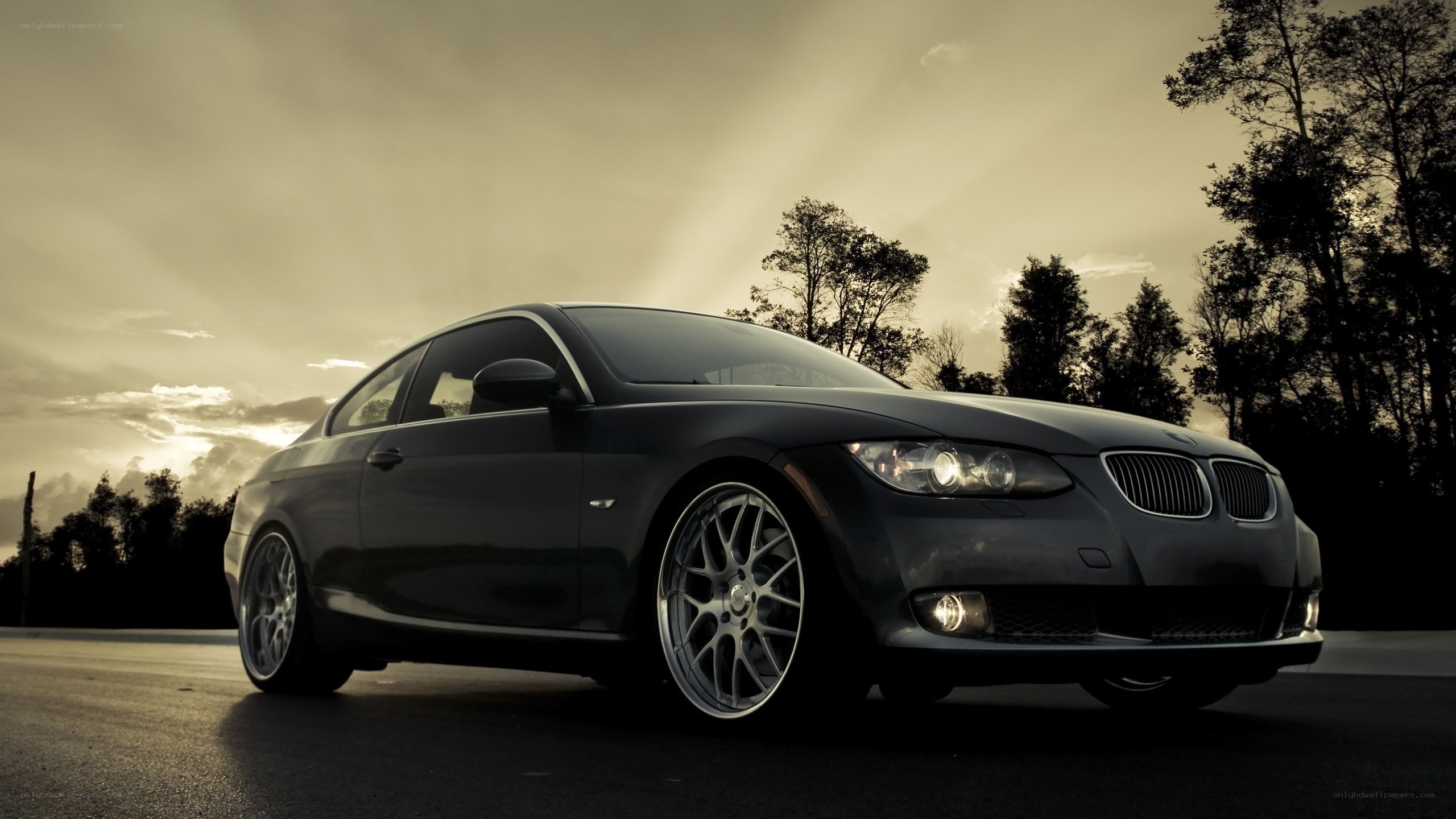 Black BMW coupe at sunset
