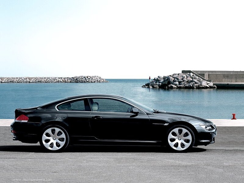 Black BMW coupe by the sea