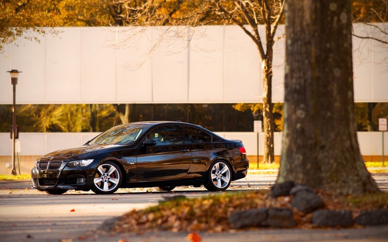 black bmw coupe in autumn
