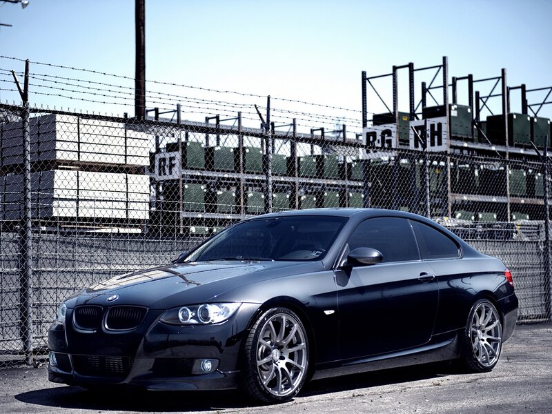 black bmw coupe in industrial area