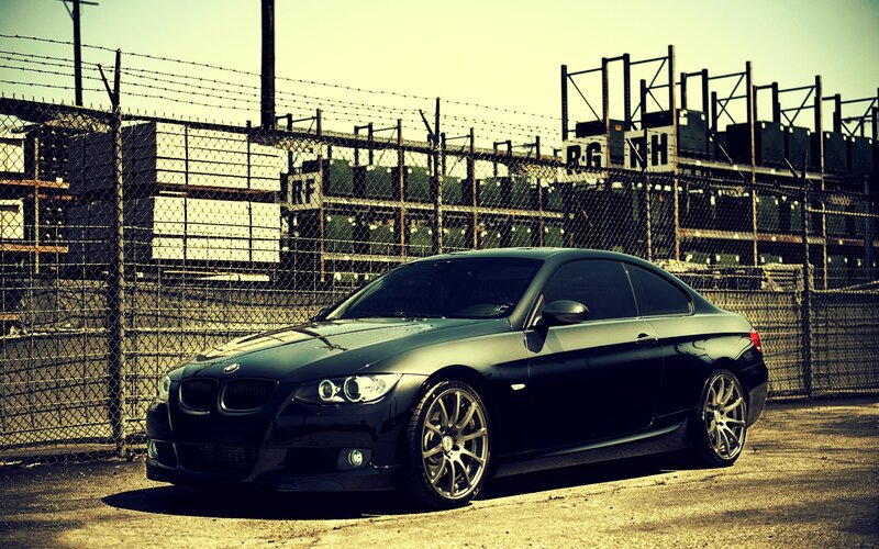black bmw coupe in industrial area