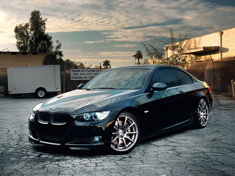Black BMW coupe in industrial lot
