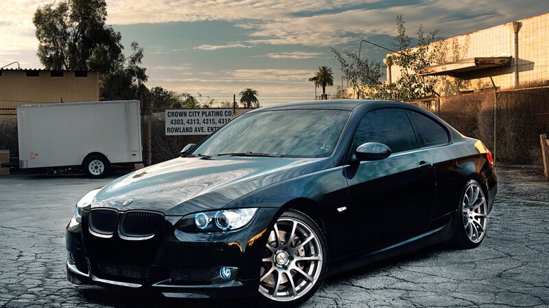 black bmw coupe in industrial lot