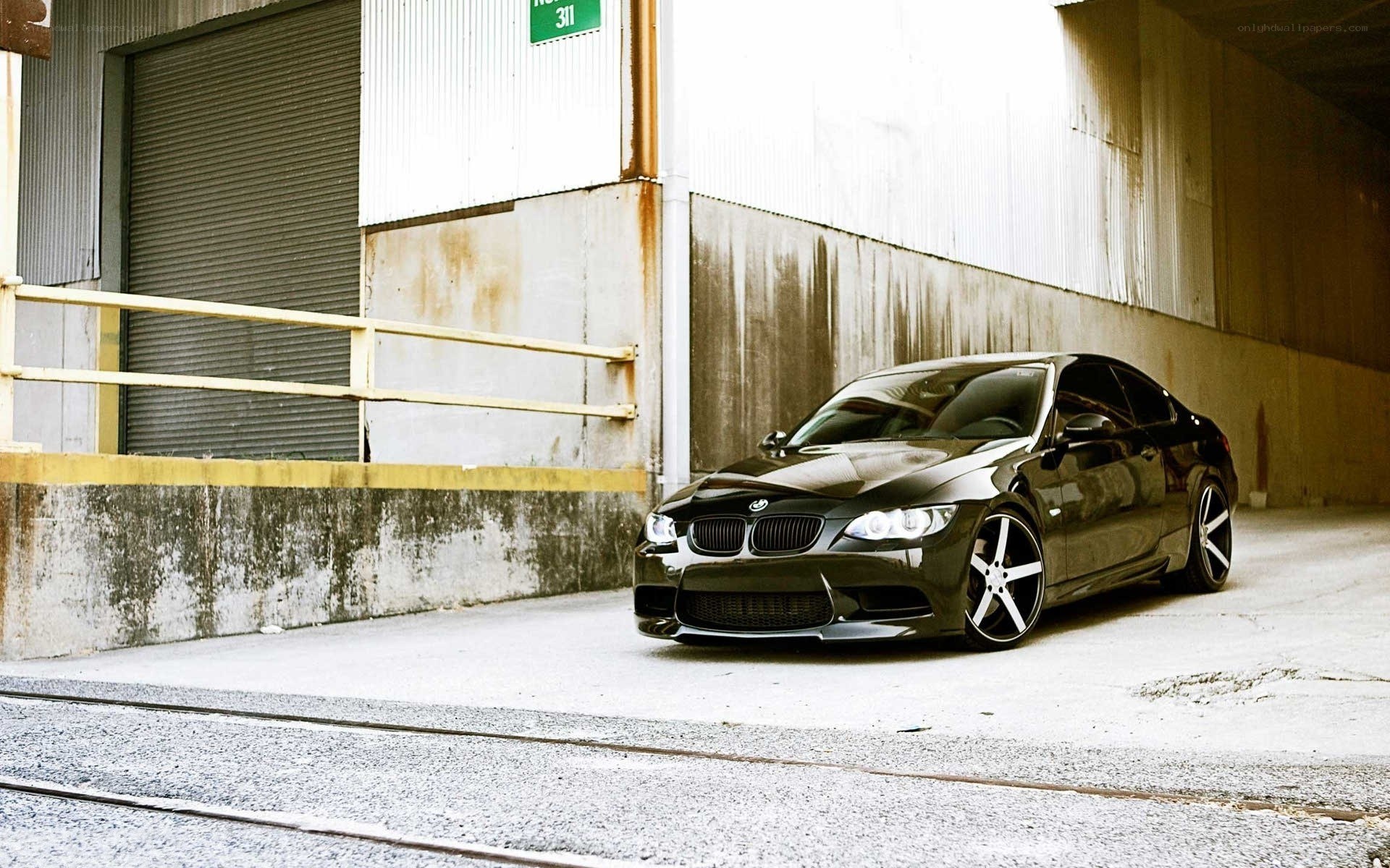 black bmw coupe in industrial setting
