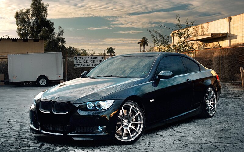 black bmw coupe in parking lot