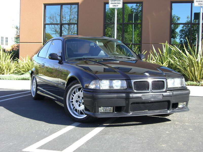 black bmw coupe in parking lot