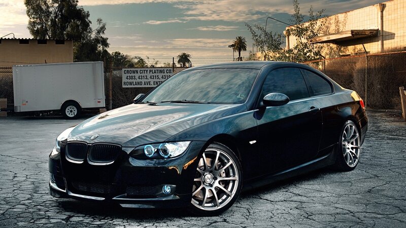 black bmw coupe in parking lot
