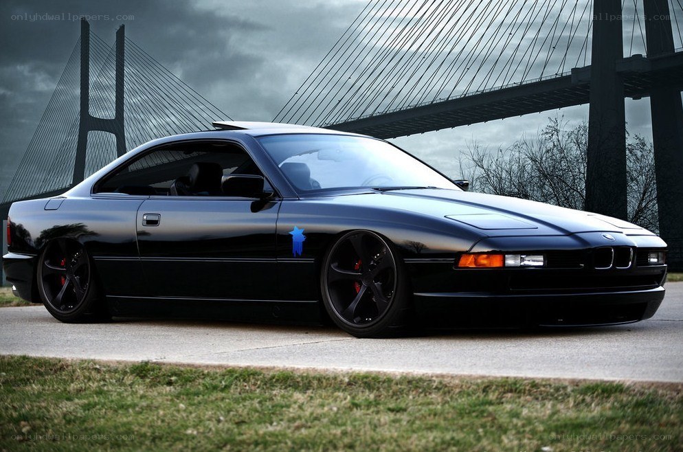 Black BMW coupe on a bridge