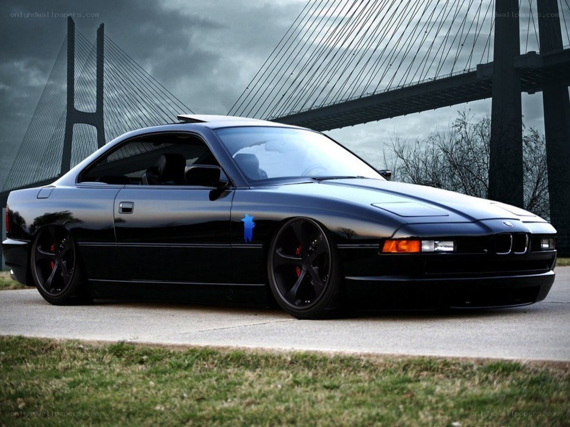 Black BMW coupe on a bridge