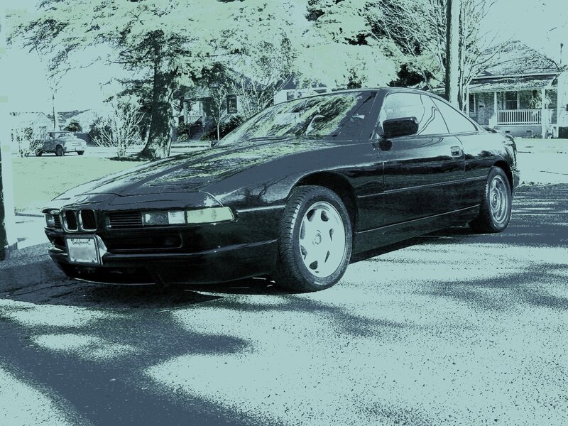 Black BMW coupe on a residential street