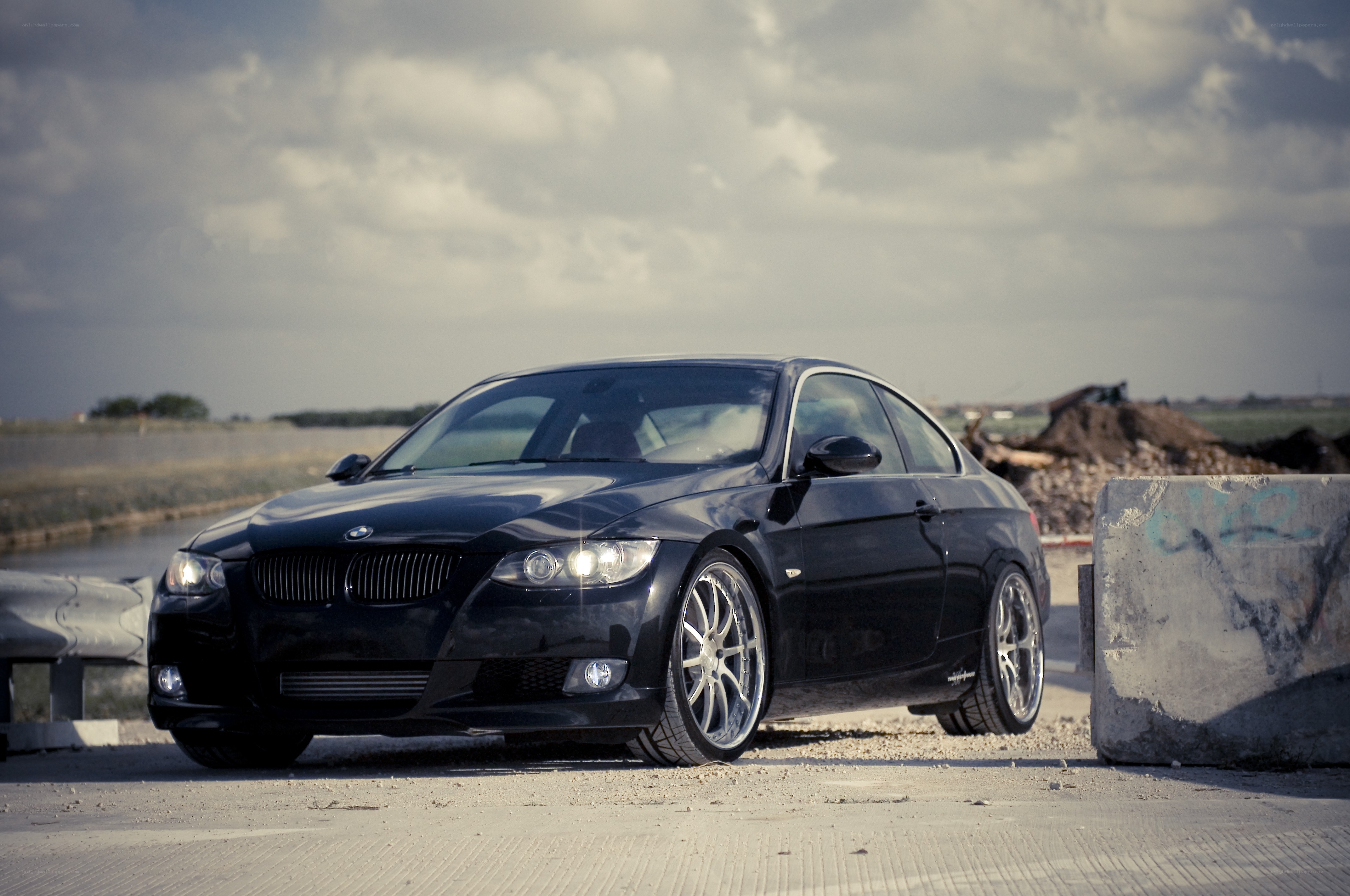 Black BMW coupe on a road