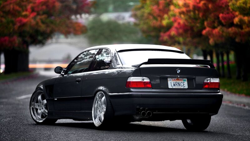 black bmw coupe on autumn street