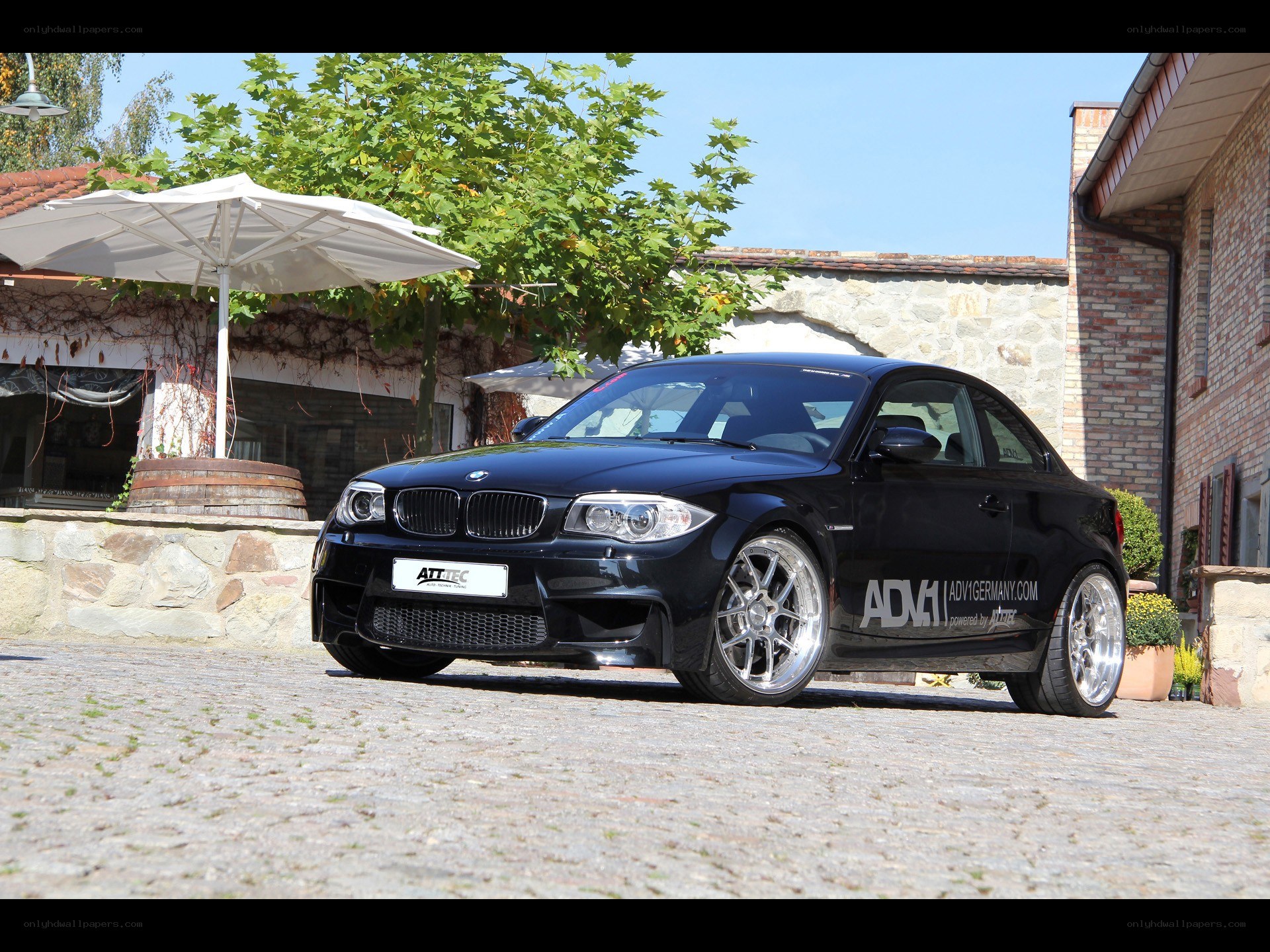 Black BMW coupe on cobblestones