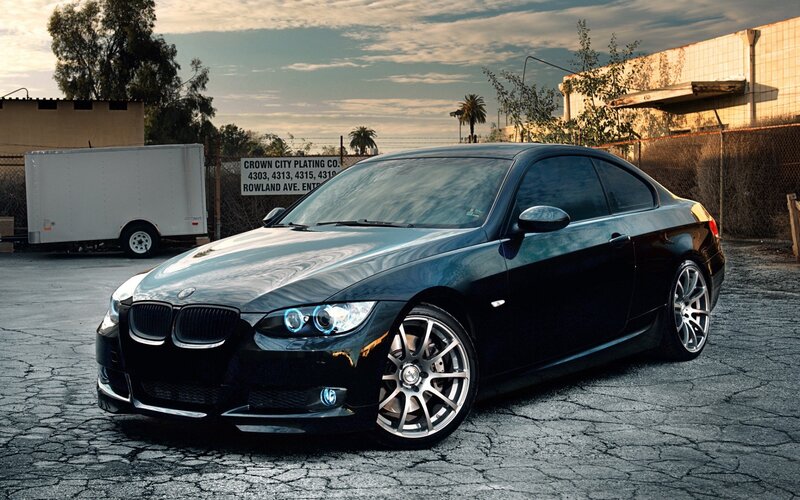 Black BMW coupe on cracked pavement