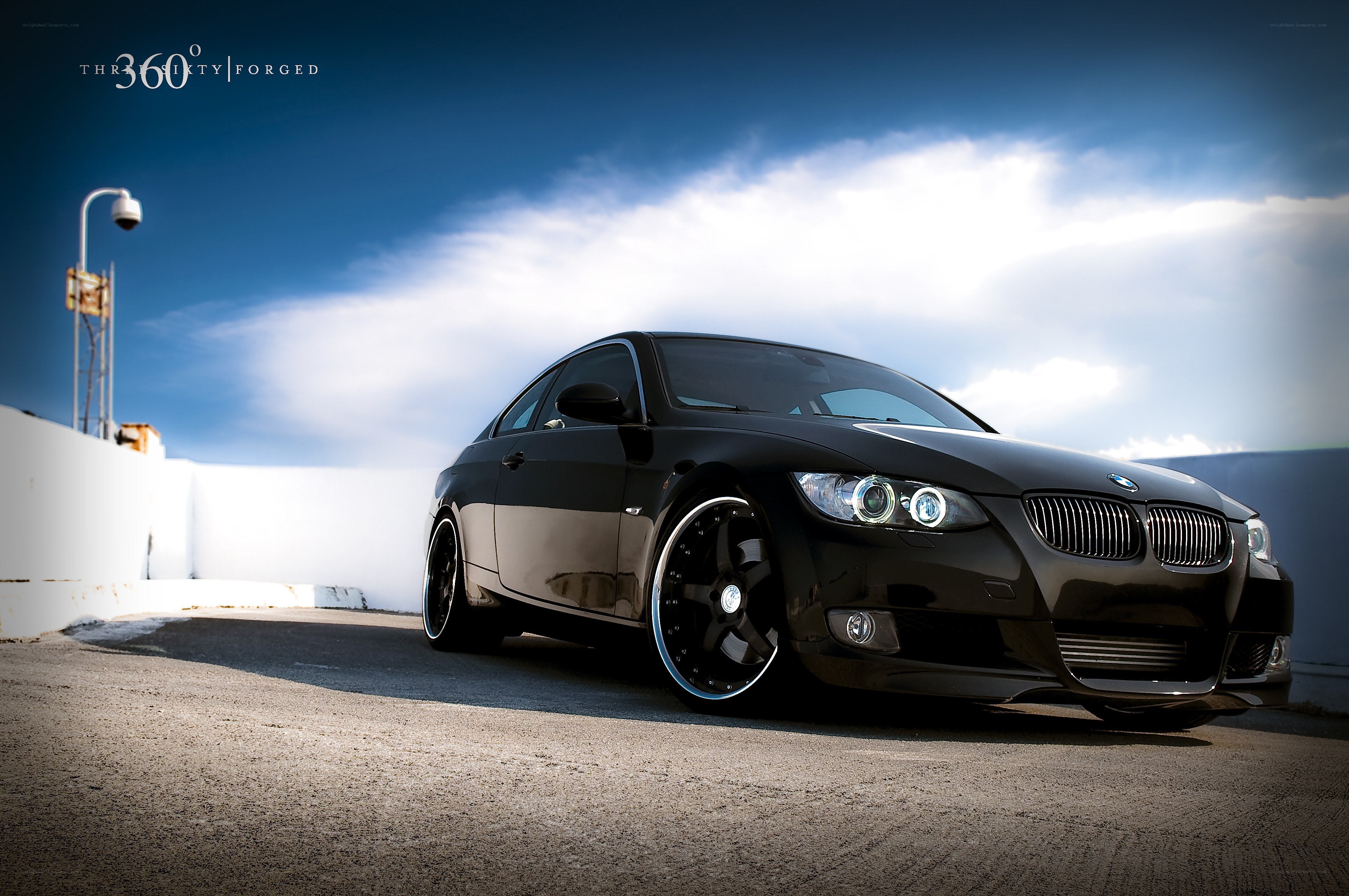 Black BMW coupe on rooftop