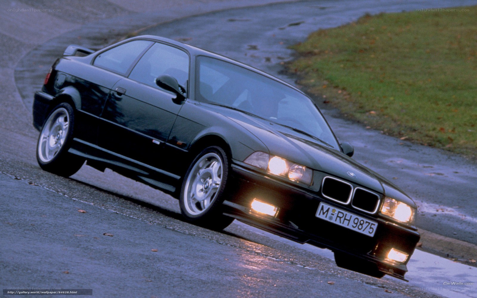 black bmw coupe on wet road