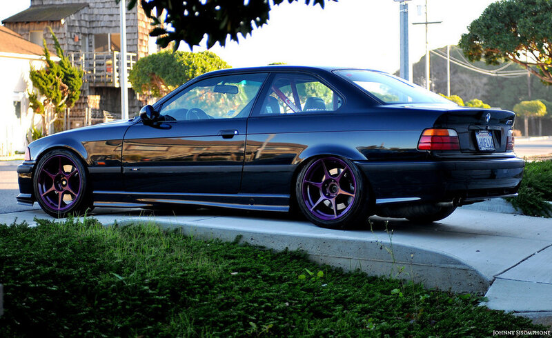 black bmw coupe with purple wheels
