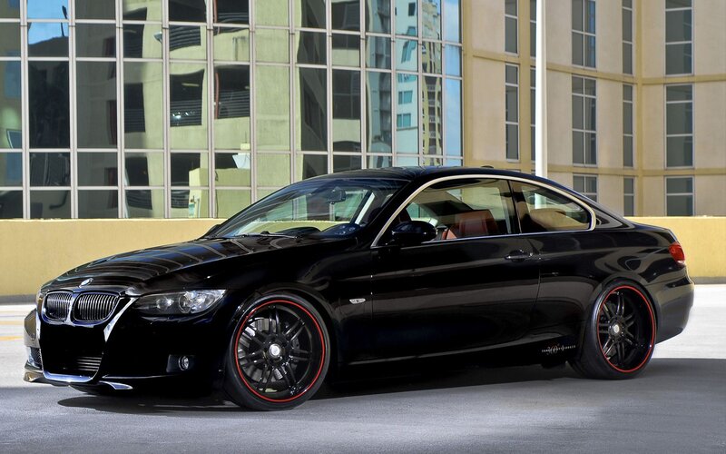 Black BMW coupe with red rims
