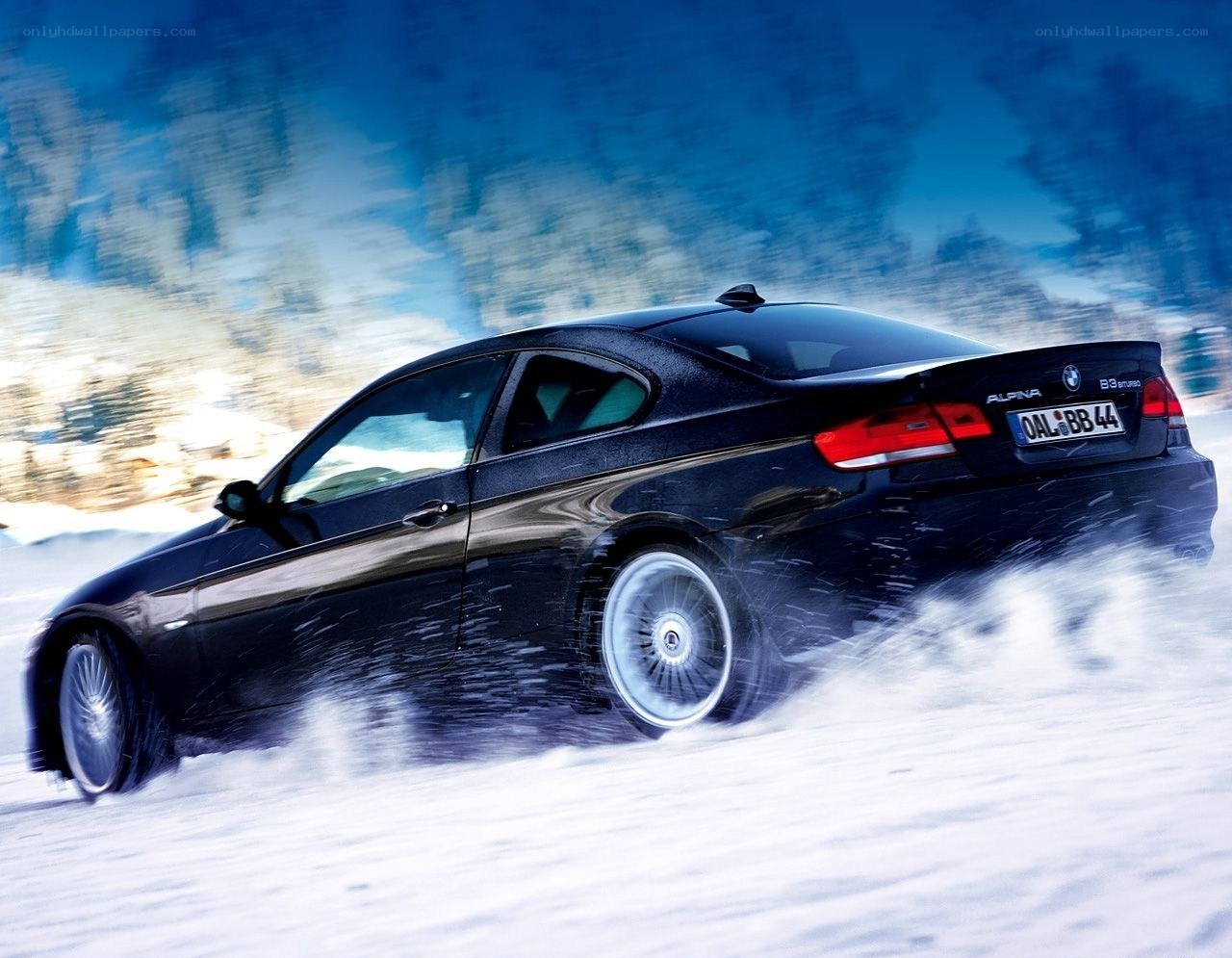 Black BMW drifting in snow